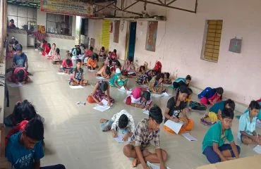 Volunteers and children learning together at the Ashram